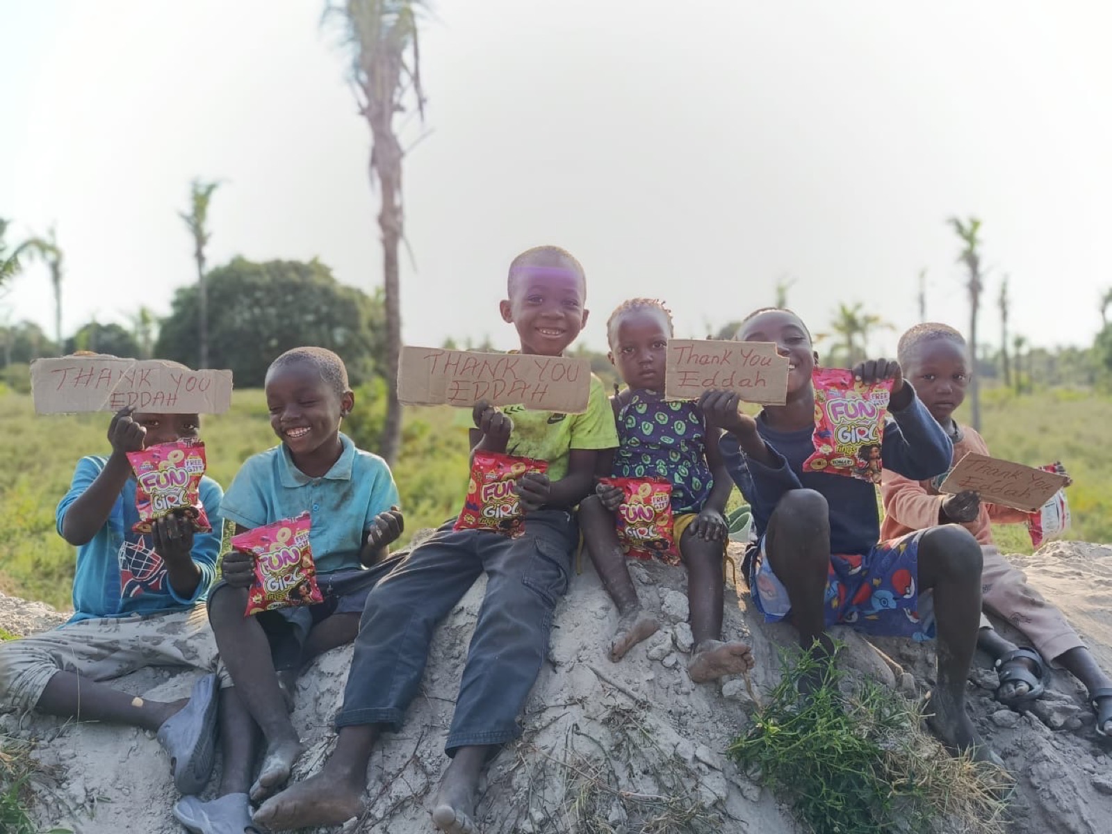 Children holding thank-you signs for Eddah